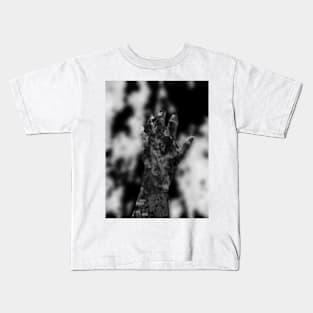 Digital collage and special processing. Psychedelic. Hand reaching on top of some bizarre surface. Grayscale, very beautiful. Kids T-Shirt